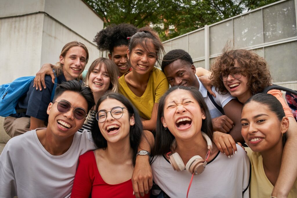 Selfie of a group of students looking at the camera laughing.